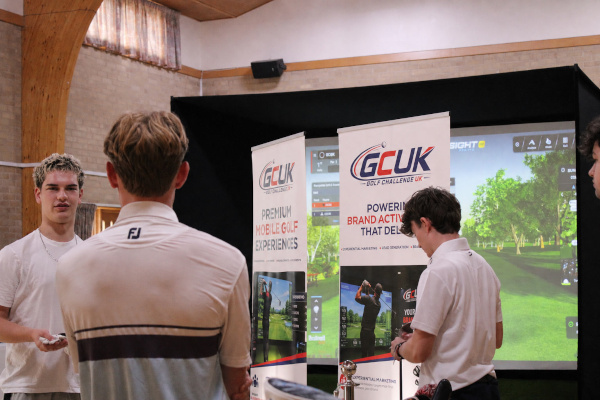 A group of men using the GCUK golf simulator